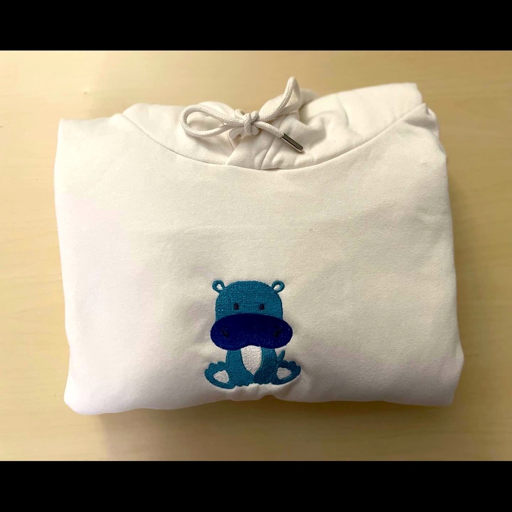 White H&M hoodie with embroidered hippo